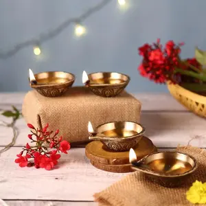 Radiant Diya Set. A gift set of four handcrafted antique brass diyas. Traditional oil lamps for every festival.